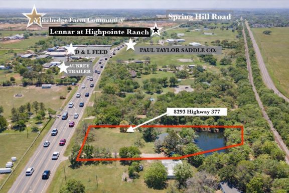 Aerial view of land with Highway 377 road frontage, featuring a pond and surrounding trees.